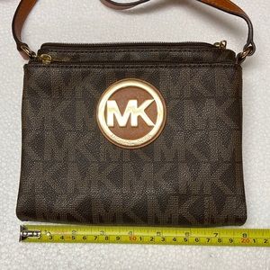 Michael Kors Triple compartment Crossbody. Gently Used. Small stain in pocket.